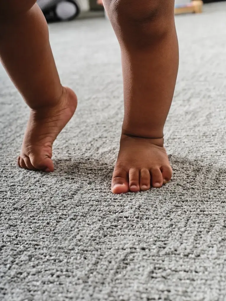 A baby's feet on soft, clean new carpet