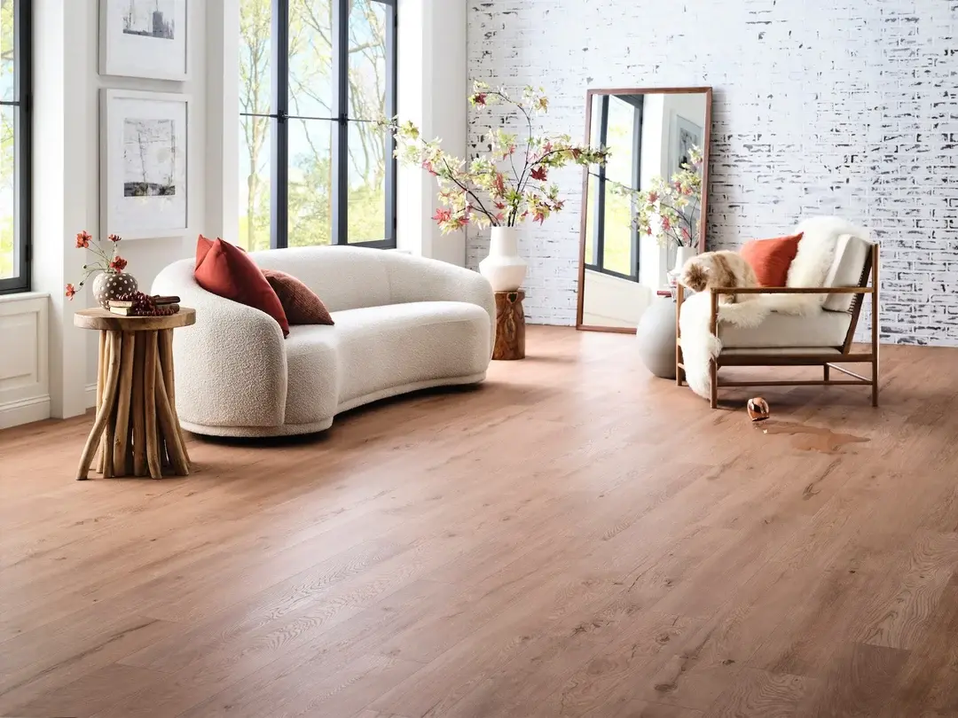 Warm wood-look plank flooring installed in a bright, open living room
